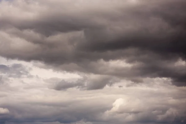 Light in the Dark and Dramatic Storm Clouds background