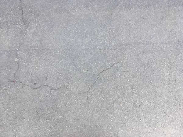 Texture of gray cracked asphalt. Cracks on the road. — Stock Photo, Image