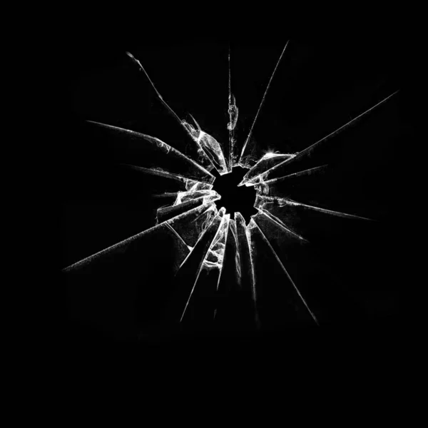 Abstrakcja stłuczonego szkła na czarnym tle. Roztrzaskane szkło. Pęknięcia i dziura w oknie. — Zdjęcie stockowe