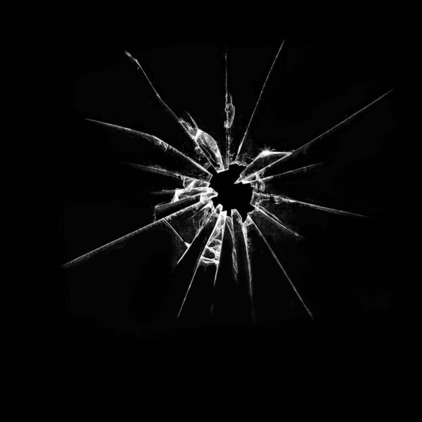 Abstraction of broken glass on black background. Vandalized glass shattered. Cracks and hole in the window.