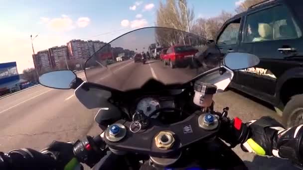 Dnepr, Oekraïne-14 april 2019: motorrijder op een blauwe sport fiets rijdt door de stad van een asfalt-overdekte weg, rijden rond de auto, stoppen op een kruispunt bij een verkeerslicht. Camera op — Stockvideo