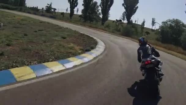 Zaporizhia, Ukrajina - 17. června 2019: motocyklista předjíždí modrou cyklistickou závodní dráhu. — Stock video