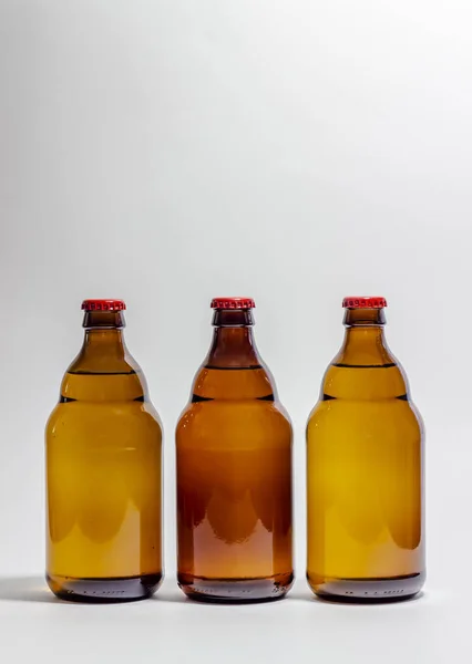 Bierflesjes met een rode kurk op een grijze achtergrond. Ontwerp. Minimalisme. Creatief idee. Mock-up. — Stockfoto