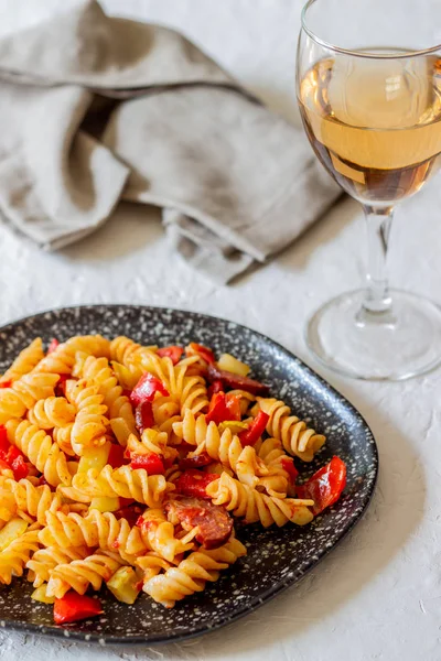 Italian pasta with vegetables and sausage. White background. National Cuisine. — Stock Photo, Image