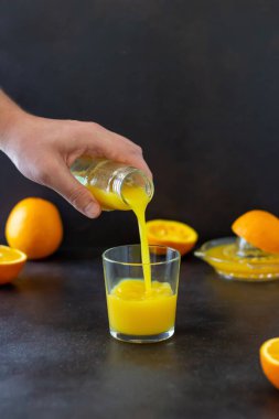 Koyu arkaplanda taze sıkılmış portakal suyu. Sağlıklı beslenme. Diyet olsun. Vejetaryen yemeği.