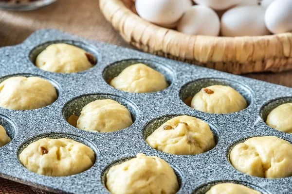 Filling a cake baking pan with dough