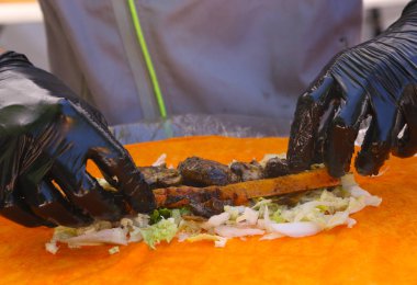 lokanta vegan rulo Sarma işlemi eldivenli elleriyle yemek ve sebze ingradients fotoğrafını ekrana kapatın