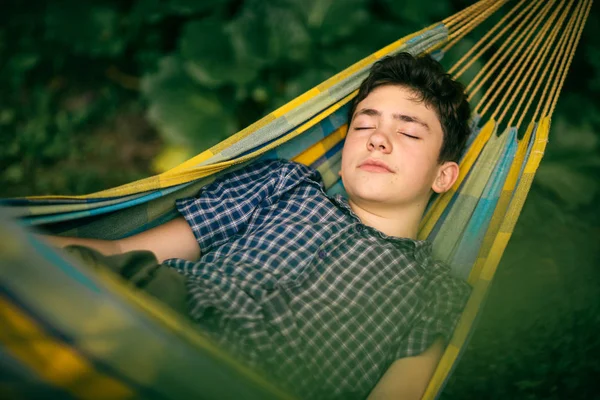 Teenager boy resting in hammock — Stock Photo, Image