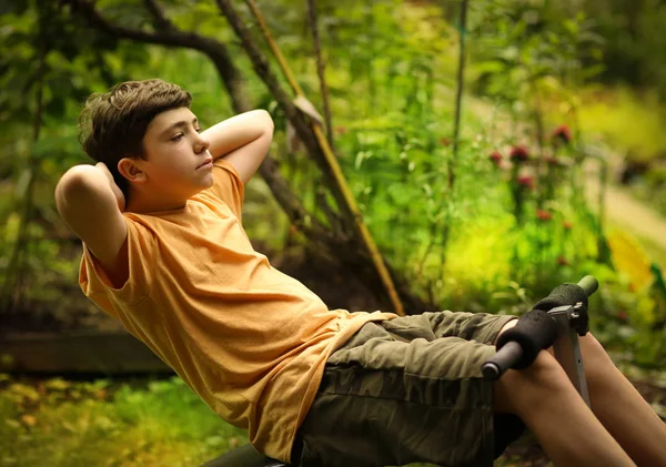 Teenager boy do push up pilates abdomen exercises on portable trainer — Stock Photo, Image