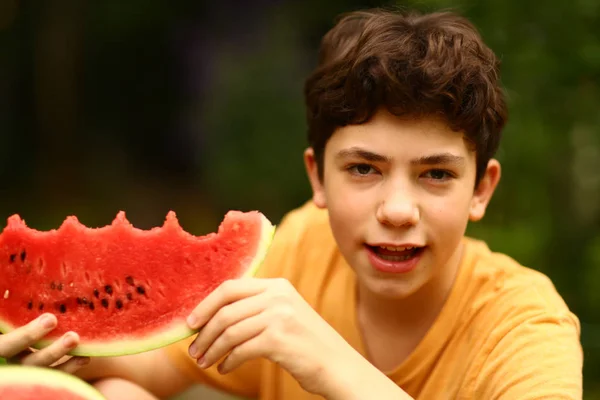 Tonåring pojke med skuren vattenmelon närbild foto — Stockfoto