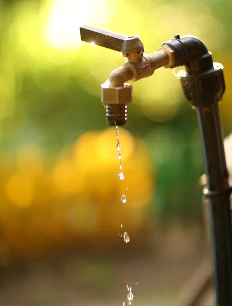 Water drops dripping from tap fasset close up photo — Stock Photo, Image