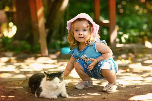 Little toddler girl stroke cat close up photo on summer outdoor background — Stock Photo, Image