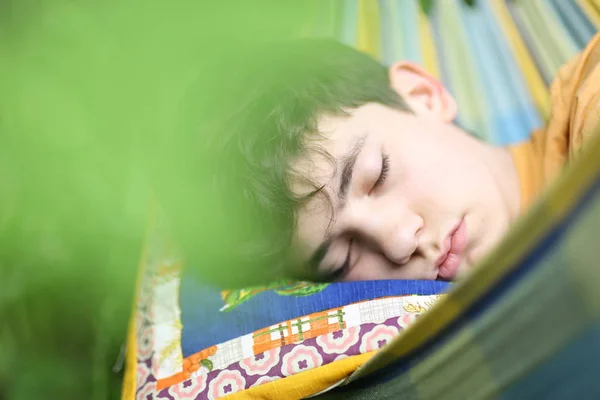 Boy resting sleep in hammock on summer green garden background — Stock Photo, Image