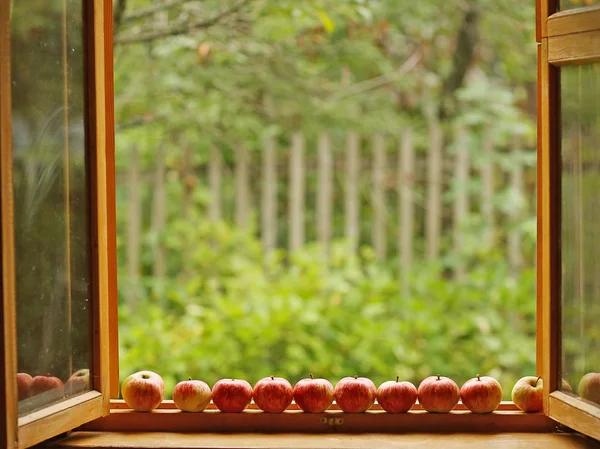 Manzanas maduras frescas en el alféizar de la ventana de madera de cerca foto —  Fotos de Stock