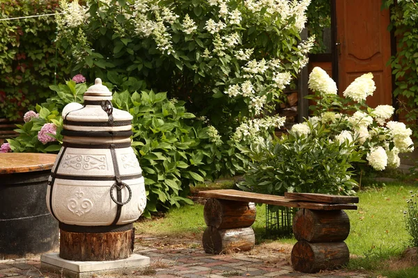 Beautiful formal garden with dining place, table tandoor bench — Stock Photo, Image