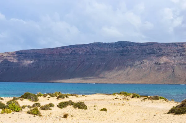 La Graciosa adasında bir plajdan görülen Lanzarote Kayalıkları — Stok fotoğraf