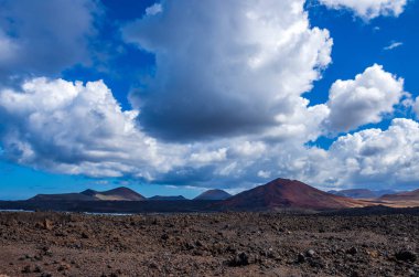 Landscape of volcanoes and solidified lava in Timanfaya national park clipart