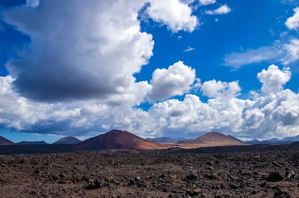 Stock image Landscape of volcanoes and solidified lava in Timanfaya national park