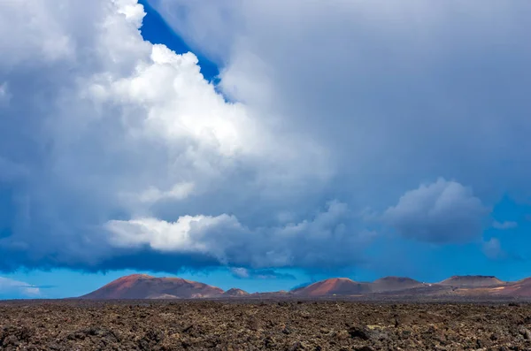 Landscape of a storm over the volcanoes of Timanvaya