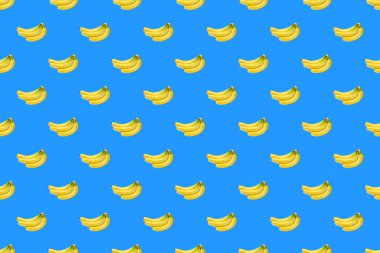 Mavi arka planda taze sarı muz deseni.