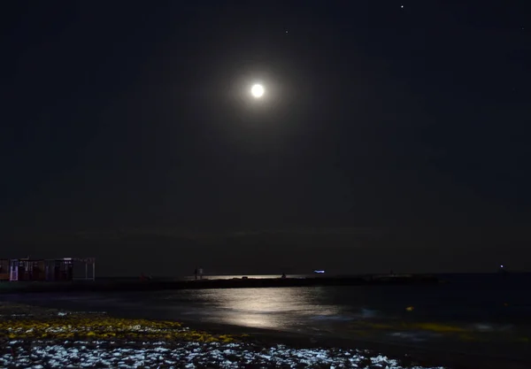 moon and moon path on the sea beach at night