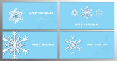 Mavi arka planda kar taneleri olan bir grup Mutlu Noeller..