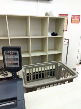 Checkout counters with an empty cart and shelves nearby.