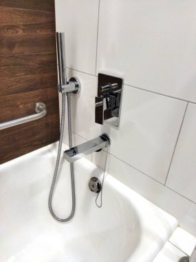 Chrome faucet and shower setup in a chic bathroom.