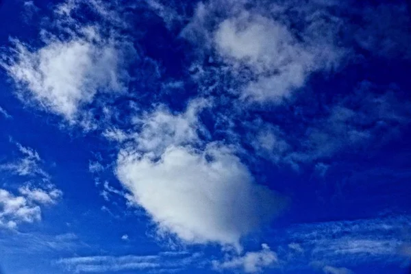 Big gray white clouds on a blue sky