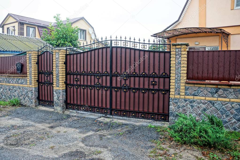 brown metal gate with black leather pattern and street fence