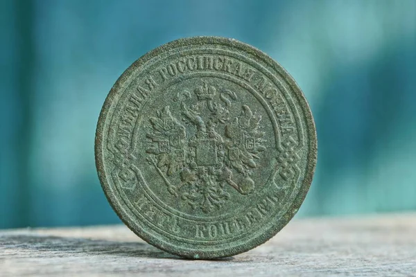 big old green copper coin with eagle