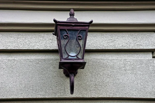 Old street lamp on a gray wall