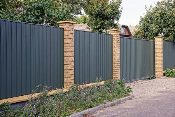 Part of the metallic green fence and the gate — Stock Image Part Metallic Green Fence Gate Royalty Free Stock Images