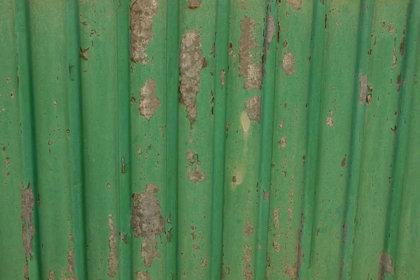 green metal texture from an old shabby iron wall
