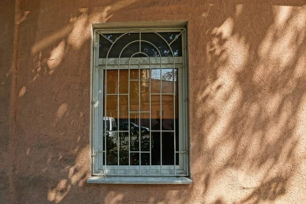 Окно Серым Железным Грилем Коричневой Бетонной Стене — стоковое фото