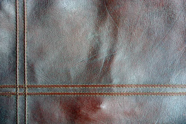 棕色皮革背景的衣服与接缝的部分 — 图库照片