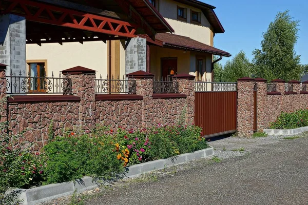 Brown brick fence and closed gates