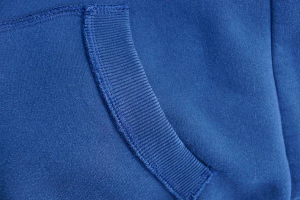 blue gray fabric texture of the jacket with a pocket