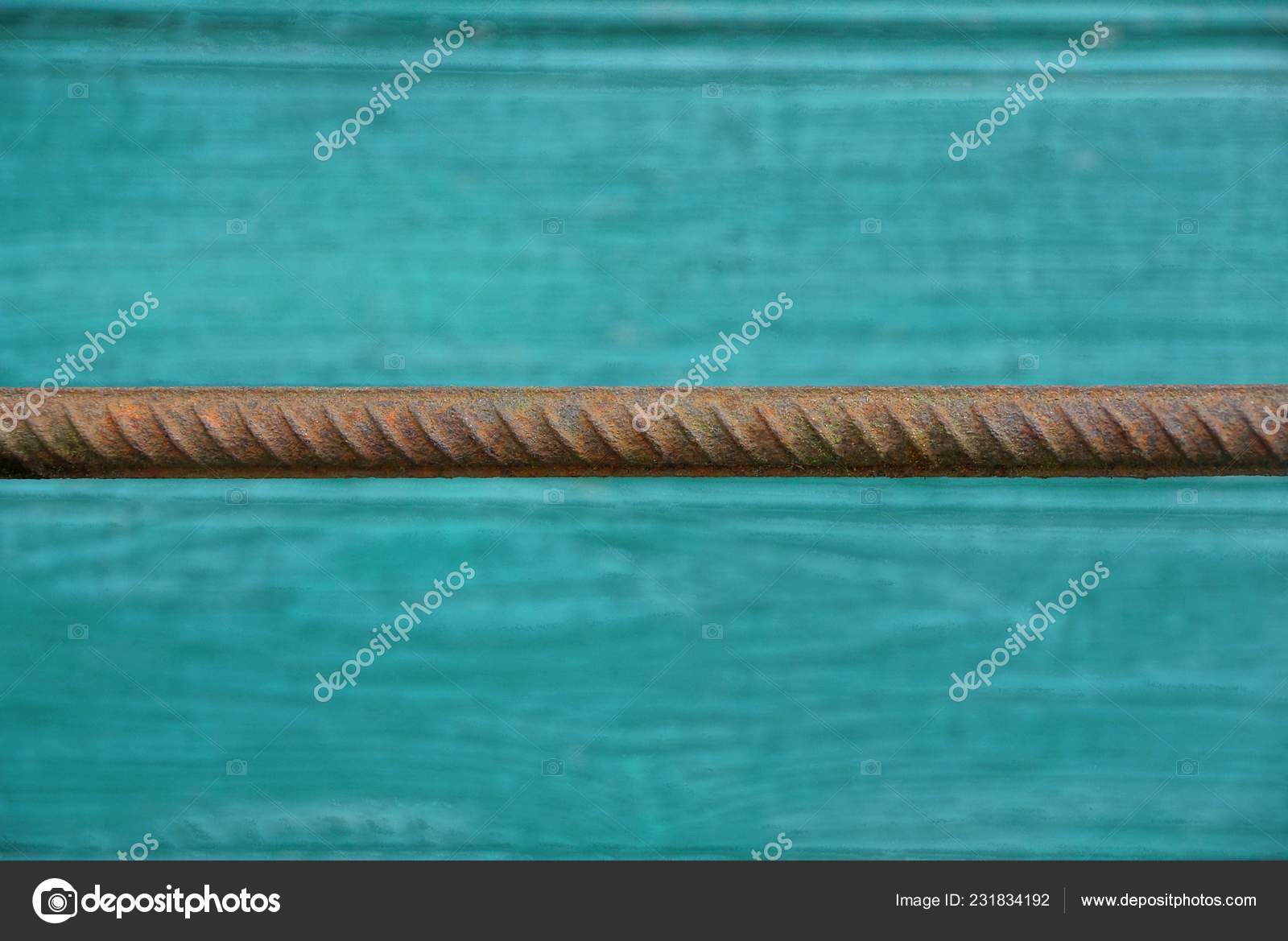 One Long Brown Iron Rod From Rebar In Rust On A Blue Background