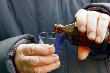 Transfusion of medicine from a bottle into a wine-glass
