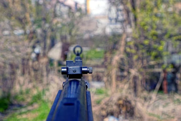 The sight on the part of the air rifle outdoors on a sunny day