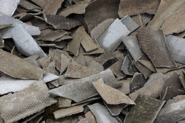 gray texture of broken pieces of slate in a pile of garbage