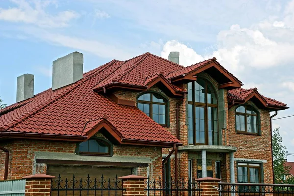 Part of a brick brick house with a red tiled roof