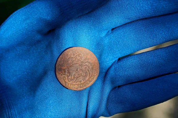 Large Old Copper Coin Lies Palm Hand Blue Glove — Stock Photo, Image