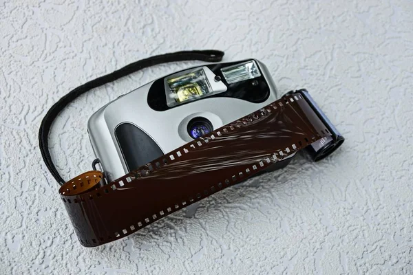 在灰色表面上有胶片的旧相机 — 图库照片