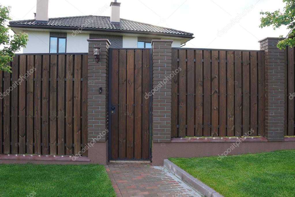 brown wooden plank fence and a closed door outside