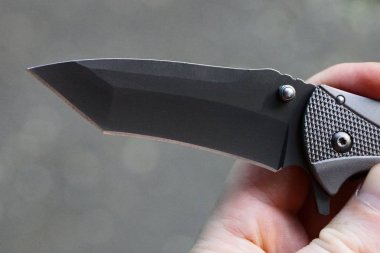 el siyah bıçak ile katlanır bıçak tutar