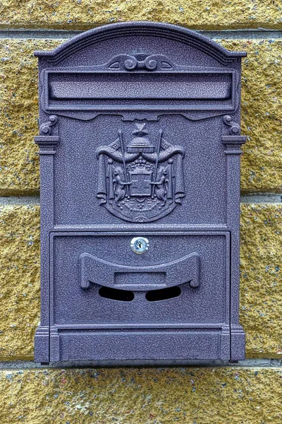 Box for mail and newspapers on a stone pillar