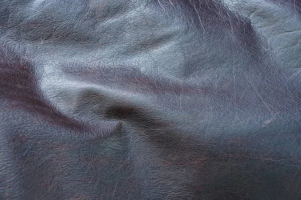 brown background of crumpled leather on clothes