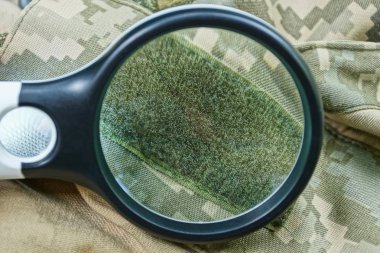 black magnifier  increases green velcro on spotty clothes clipart
